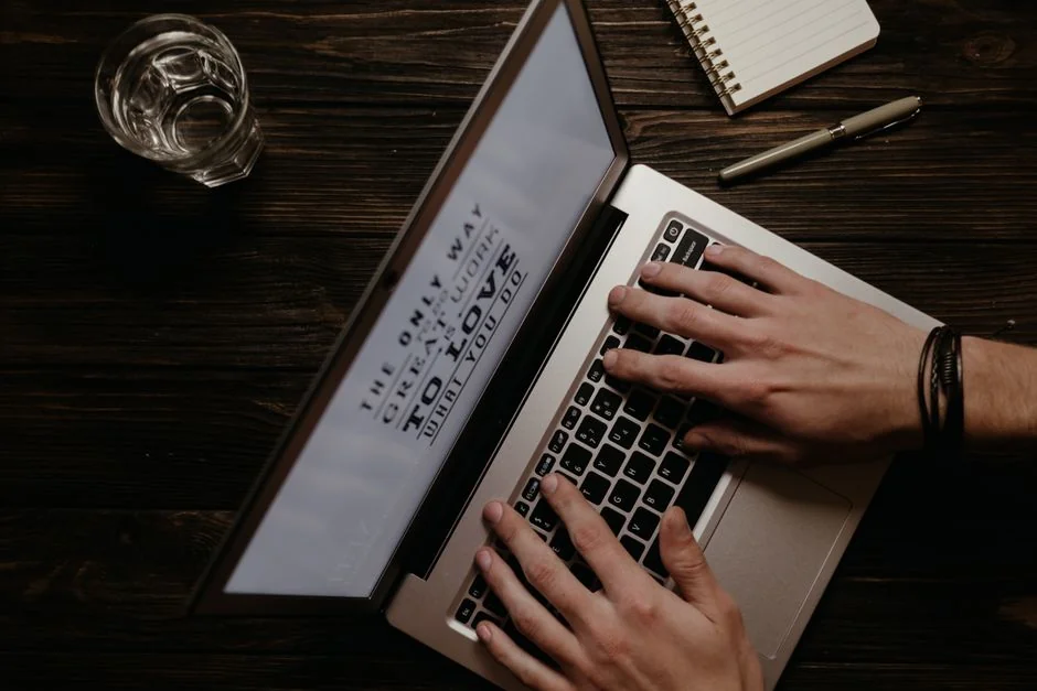 A diverse team collaborating on digital marketing strategies at a desk, using laptops and tablets.